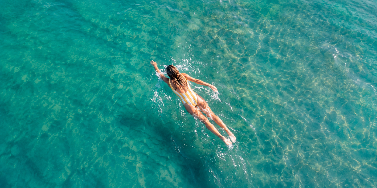 Swimmer in clear turquoise ocean water