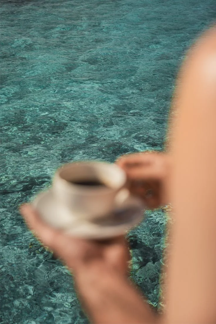 Slow coffee beside turquoise water