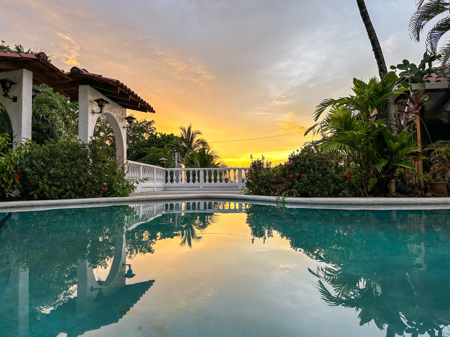 Swimming pool and tropical surroundings at Ocean Vista Tamarindo
